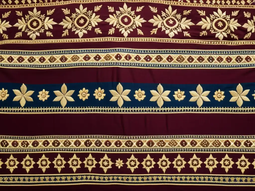 Un antiguo textil funerario hindú, bordado con ricos colores de marrón, dorado y azul real